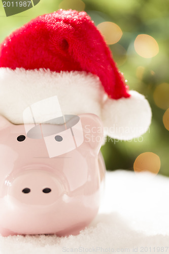 Image of Pink Piggy Bank with Santa Hat on Snowflakes