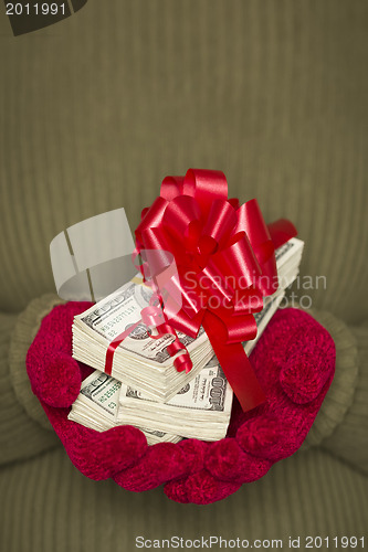 Image of Woman Wearing Mittens Holding Stacks of Money with Red Ribbon
