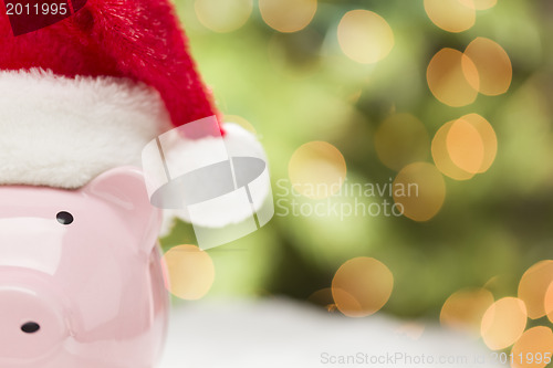 Image of Pink Piggy Bank with Santa Hat on Snowflakes