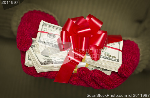 Image of Woman Wearing Mittens Holding Stacks of Money with Red Ribbon