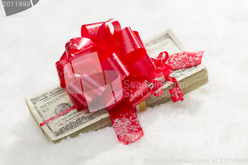 Image of Stack of Hundred Dollar Bills with Red Ribbon on Snow