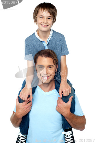 Image of Adorable young son enjoying piggyback ride