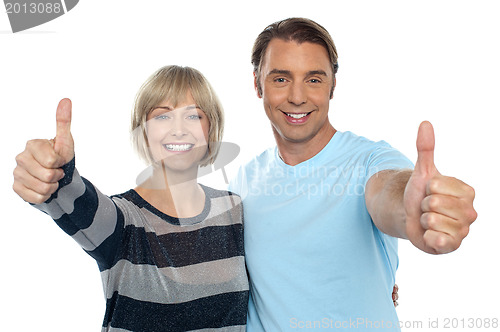 Image of Confident couple showing thumbs up sign