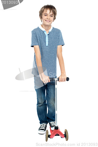 Image of Smart young boy posing with his push scooter