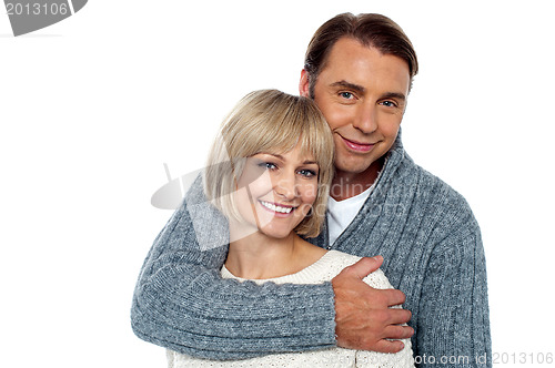 Image of Stylish man embracing his wife from behind