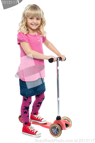 Image of Little girl enjoying her toy scooter ride