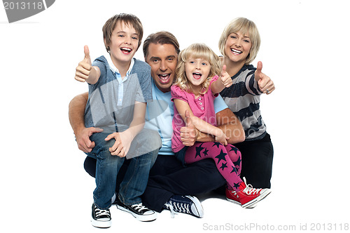 Image of Cheerful thumbs up family