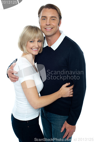 Image of Stylish man in pullover embracing his blonde wife