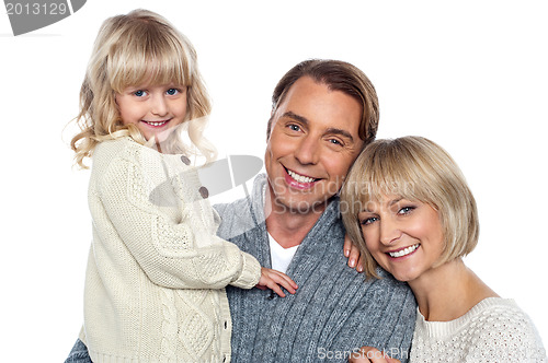 Image of Cheerful family of three posing for camera