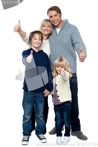 Image of Adorable family in winter clothes gesturing thumbs up