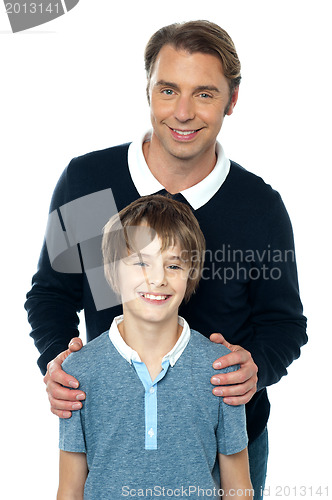 Image of Man in blue pullover posing with his son