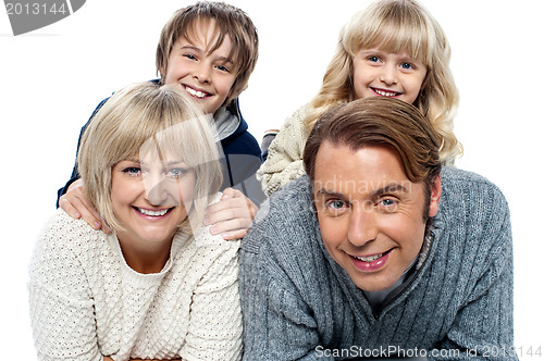 Image of Spirited kids having fun with their parents indoors