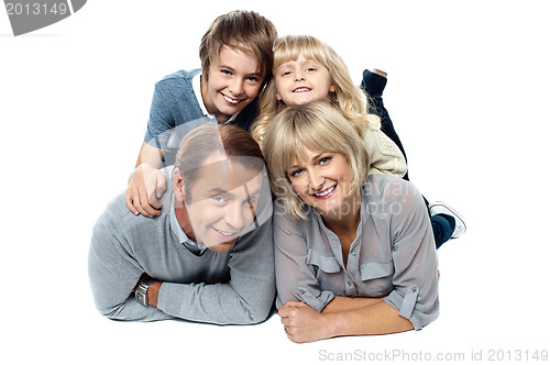 Image of Adorable young kids piled on top of their parents