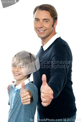 Image of Confident father and son duo gesturing thumbs up