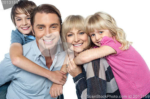 Image of Happy family of four members posing together