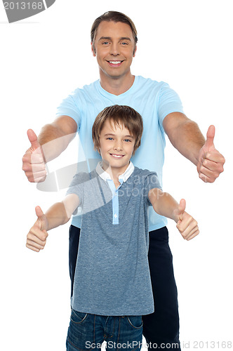 Image of Handsome father and son showing thumbs up to camera