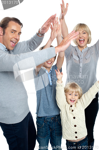 Image of Jubilant family celebrating and partying indoors