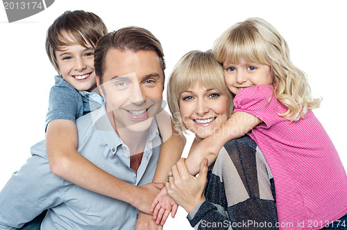 Image of Fun loving family of four. Kids enjoying piggy ride.