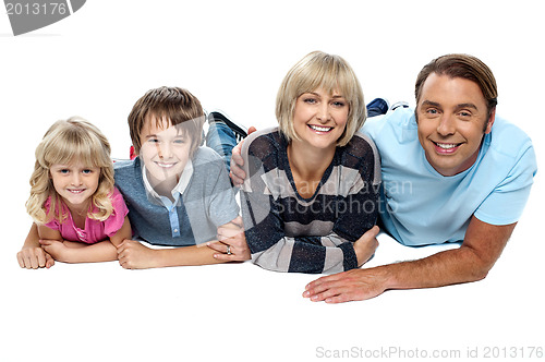 Image of Smiling family of four relaxing on white background