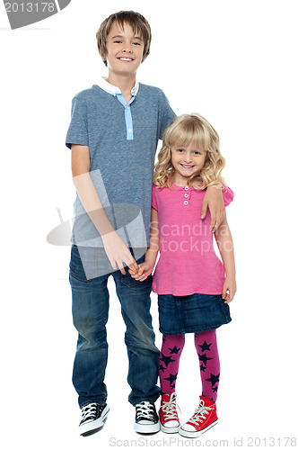Image of Smart boy holding cute sisters hand and embracing her