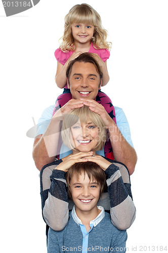 Image of Attractive smiling family of four posing in a single line