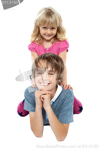 Image of Adorable sister sitting on her brothers back
