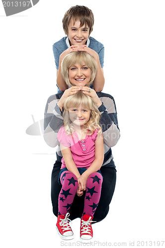 Image of Mother posing with her adorable son and daughter