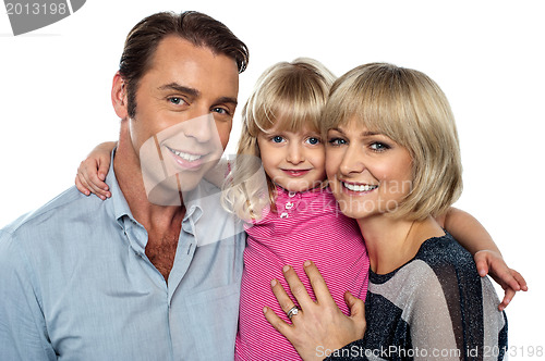 Image of Stylish little daughter embracing her parents