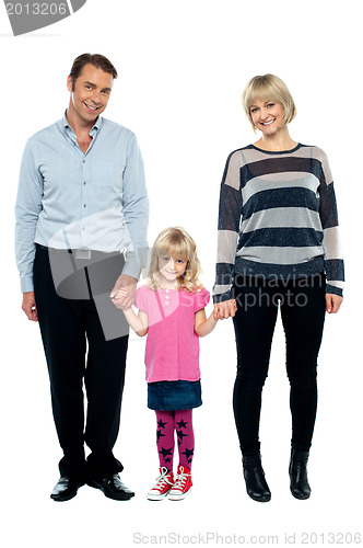 Image of Cute daughter holding hands of her parents tightly