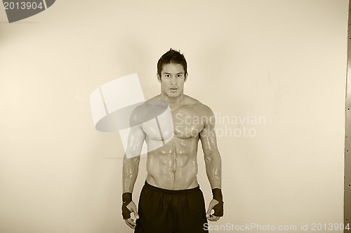 Image of vintage image of muscle man posing in gym