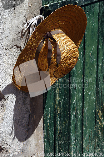 Image of Stylish straw hat on the wall