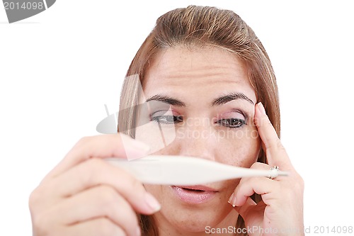 Image of Sick woman looking at a clinical thermometer 