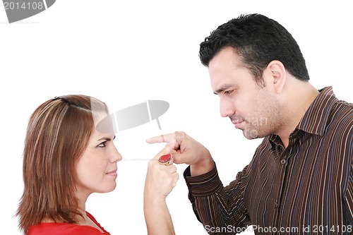 Image of Young couple pointing at each other against a white background 