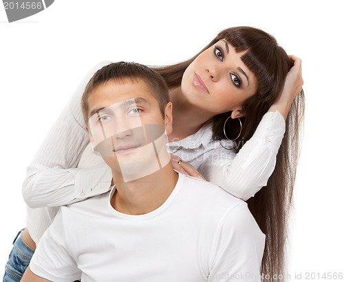 Image of portrait of a beautiful young couple in the studio on a white ba