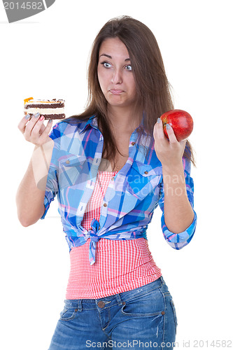 Image of Girl in doubt with an apple and a cake