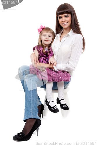 Image of mother with a cute daughter sitting on a chair