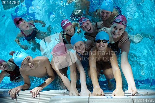 Image of happy children group  at swimming pool