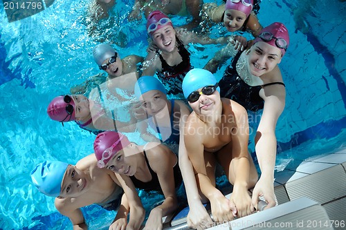 Image of happy children group  at swimming pool