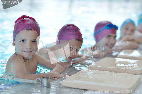 Image of happy children group  at swimming pool