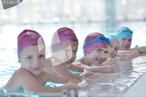 Image of happy children group  at swimming pool