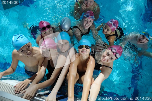 Image of happy children group  at swimming pool