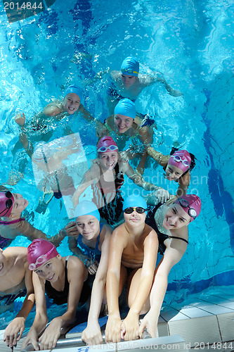 Image of happy children group  at swimming pool