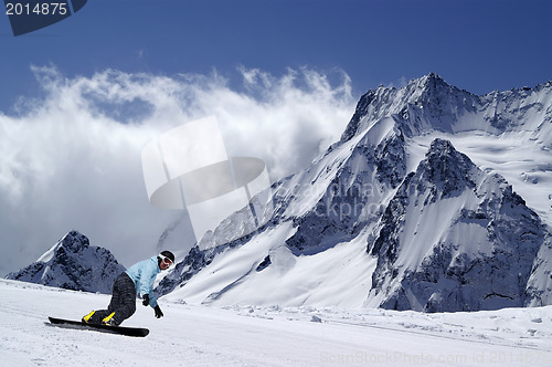 Image of Snowboarder on piste slope