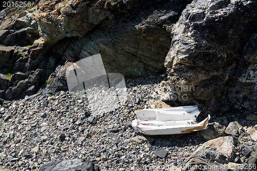 Image of Smashed boat on rocky beach