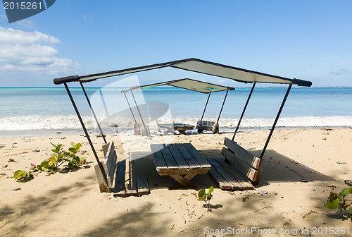 Image of Table and chairs covered by sand on beach