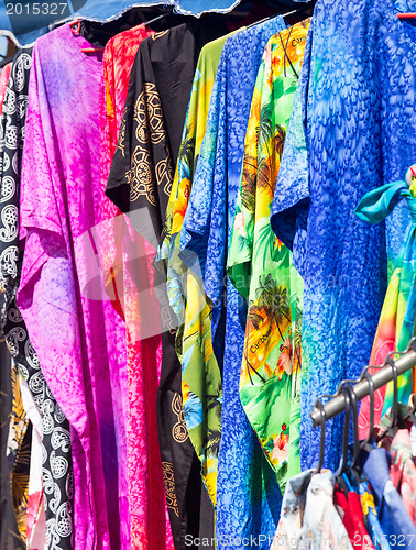 Image of Clothing and fabrics in street market stall