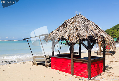 Image of Table and chairs covered by sand on beach