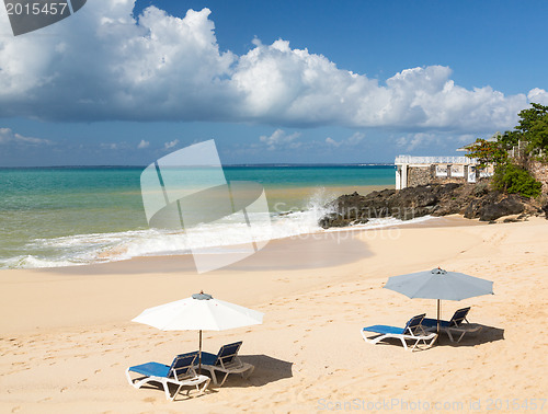 Image of Reclining chairs and umbrella on Baie Rouge