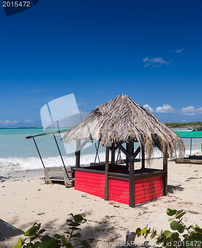 Image of Table and chairs covered by sand on beach