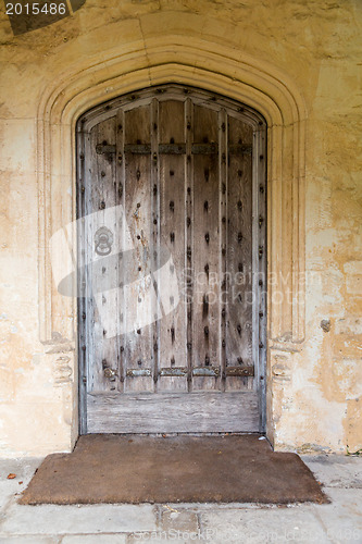 Image of Ancient oak wooden door in stone surround